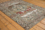 Distressed Malayer rug: faded scalloped medallion, palmettes, and muted multi-toned field.