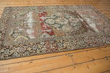 Muted floral border and distressed main field of a vintage Malayer rug.