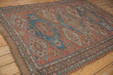 Natural brown fringe with zig-zag and wave patterned borders on an antique Soumac carpet.