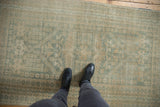 Distressed vintage Oushak rug's soft pile and seafoam green, sand patterns underfoot.