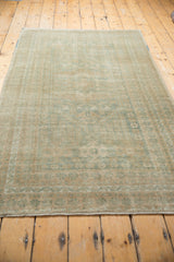 Secured end and fringe of vintage distressed Oushak rug, with even wear.