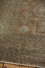 Distressed vintage Sivas carpet with worn geometric and stylized motifs in coffee and beige.