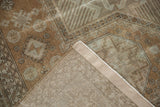 Folded corner of a distressed Sivas carpet, revealing hand knotted foundation and intact selvage.