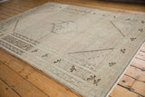 Distressed vintage Sivas rug showing lattice Herati field and agricultural main border.
