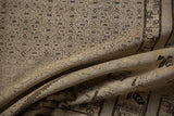 Folded distressed Sivas carpet; beige Herati field and charcoal agricultural border pattern.