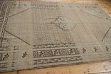 End of a distressed Sivas carpet with agricultural main border and Herati-inspired field.