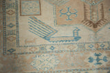 Hand-knotted Afghani Caucasian carpet featuring a finned bird motif, turquoise, ivory, and beige geometric patterns.