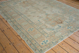 Corner of an Afghani Caucasian rug, showing turquoise finned bird motifs, intact selvage, and fringe.