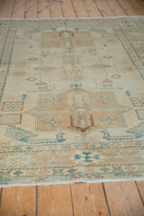 Turquoise finned birds and beige geometric tribal motifs.