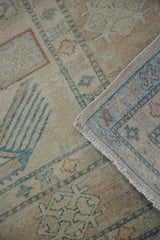 Original side selvage and short pile of Afghani Caucasian rug with ivory, beige, turquoise patterns.