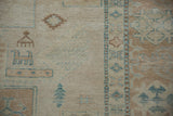 Detail of Afghani Caucasian rug with stylized animals in ivory, turquoise, and sand.