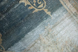 Distressed Vintage Oushak rug, dark blue and ivory field with curvilinear vine, visible foundation wear.