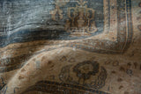 Distressed Oushak rug showing worn texture, exposed foundation, and blue-beige floral vines.