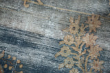 Distressed Oushak carpet, worn blue and beige floral motifs, exposed foundation.