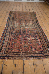 Vintage Hamadan runner with oversized Herati motif, deep blush, indigo blue, and threadbare areas.