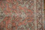 Distressed vintage Sivas rug: terracotta field, worn beige patterns, and blue border.