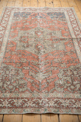 Distressed texture and traditional curvilinear motifs on the terra cotta Sivas rug border.