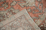 Distressed Sivas rug corner, terracotta pile, visible hand-knotted foundation, and intact selvage.