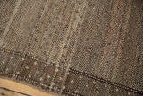 Vintage distressed Oushak carpet showing low pile texture and speckled sand and brown design.