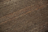 Pile texture of a distressed Oushak rug, showing even wear and earthen brown tones.