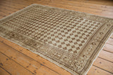 Distressed Oushak rug with abrashed ivory and coffee brown lattice fading to floral guls.