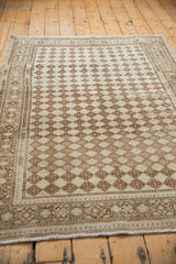 Distressed ivory and coffee brown Oushak rug showing unique diamond lattice and borders.