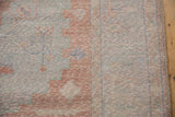 Distressed vintage Oushak carpet texture, revealing worn pile, blush, and pale powder blue.