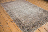 Multi-paneled diamond lattice border on a distressed Turkish Sparta rug, muted tones.