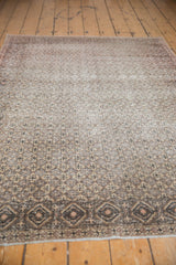 Distressed Sparta rug's intricate diamond lattice field and geometric border in silver, beige.