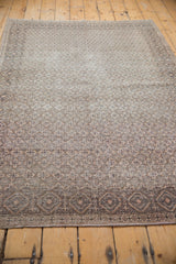 Distressed silver and beige diamond lattice border on the vintage Sparta rug.