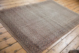 Distressed Turkish Sparta rug corner, revealing faded silver and sand lattice with even wear.