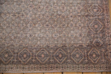 Distressed Sparta rug showing worn texture, geometric diamond border, and faint foundation.