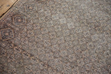 Close-up of vintage distressed Sparta rug, intricate diamond lattice with faint foundation.