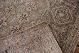 Distressed vintage Sparta rug corner, revealing its geometric lattice and hand-knotted reverse.