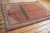 Vintage Persian Sarouk rug showing Serbend main border and germinating plant motif field.