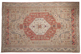 Vintage distressed Oushak carpet with a blush diamond medallion and floral motifs on a beige field.
