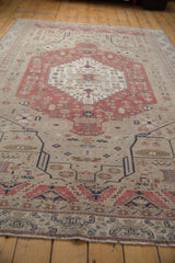 Low angle view across a vintage Oushak rug, highlighting its even wear and distressed pile.