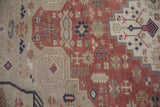 Hand-knotted pile detail of a distressed Oushak with blush, beige, and blue floral motifs.