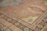 Vintage Distressed Khotan carpet corner, showing copper brown field, aqua blue flowers, and geometric border.