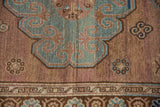 Distressed Khotan carpet with aqua blue scalloped medallion, faded floral field, geometric border.