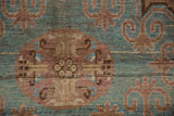 Vintage distressed Khotan carpet with aqua blue, chestnut floral pattern, even wear, faint foundation.
