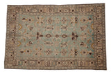 Vintage distressed Hamadan rug with an allover geometric pattern in seafoam green, beige, and brown.