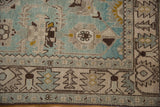 Evenly worn knot heads on a distressed Hamadan rug with seafoam green floral palmettes.