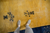 Saffron yellow vintage Chinese Peking rug field, indigo potted plants, long stems, border detail.