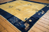 Pictorial potted plants and blossoms on the indigo border of a vintage Peking rug.