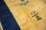 Cobalt blue potted plant motif on saffron yellow field of a vintage Peking rug.
