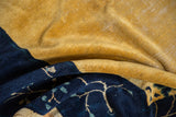 Textured saffron and indigo pile with pictorial vine motifs and knot heads.