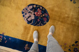 Detailed pictorial florals in roundel medallion on saffron yellow Art Deco rug.