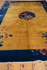White fringe and detailed blush floral motif on the cobalt blue border of this Art Deco rug.