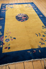 Floral vines, blush flowers, and saffron yellow field at the Art Deco Nichols rug corner.